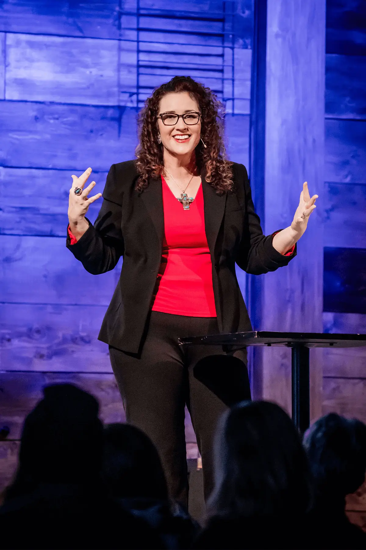 Amberly Neese speaking on stage at a women's event