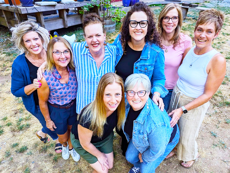 Amberly Neese laughing with a group of women at an event