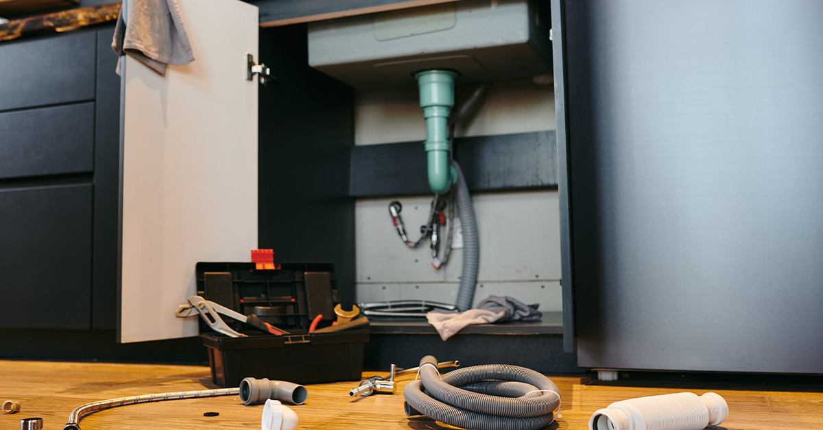 Burst pipe under a sink with water damage — Amberly Neese blog on pride and asking for help